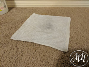 Place wash cloth over stain on carpet