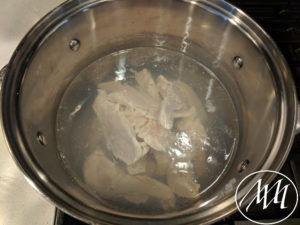 Chicken boiling in pot