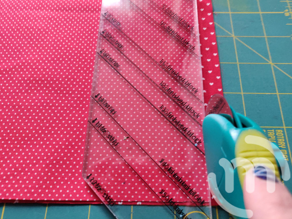 Using rotary cutter to cut fabric