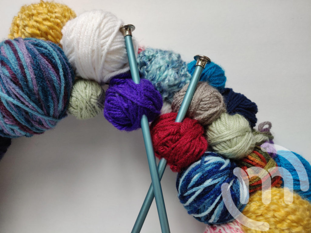 Close up of knitting needles. 